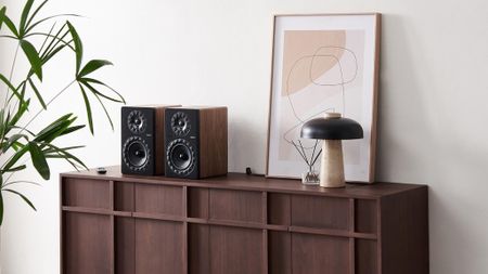 Elipson Prestige Facet II 6 Active BT speakers on top of a wooden sideboard