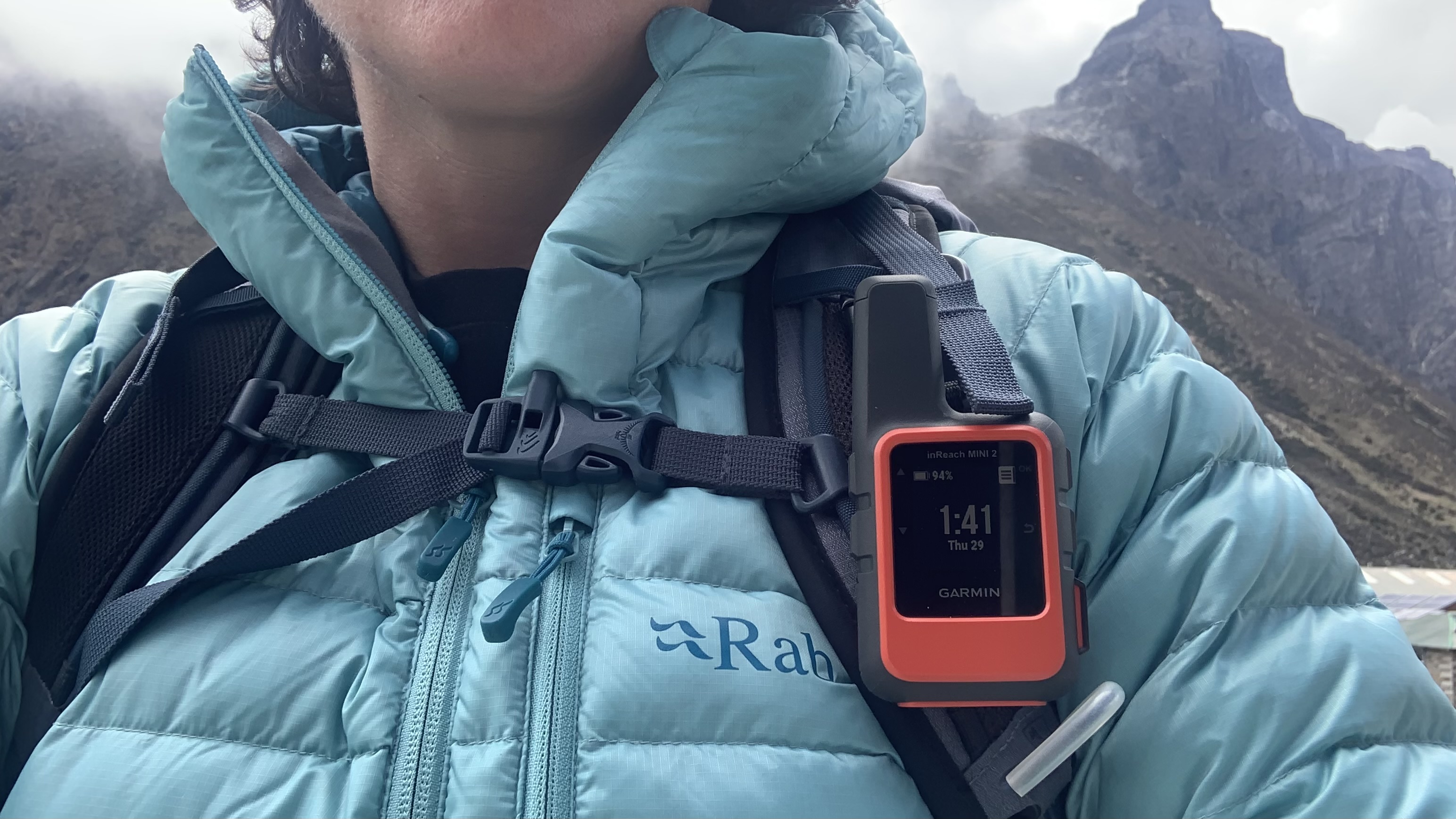 Garmin inReach Mini 2 clipped to a hiker's backpack