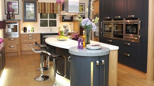 kitchen with wooden cabinets white countertop seats and wooden flooring