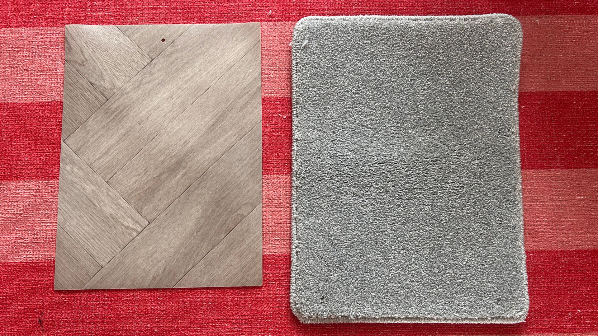 A vinyl sample and carpet sample laid out on Megan's pink and red stripy rug