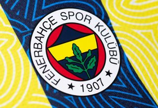 The Fenerbahce badge on a blue and yellow striped shirt shirt