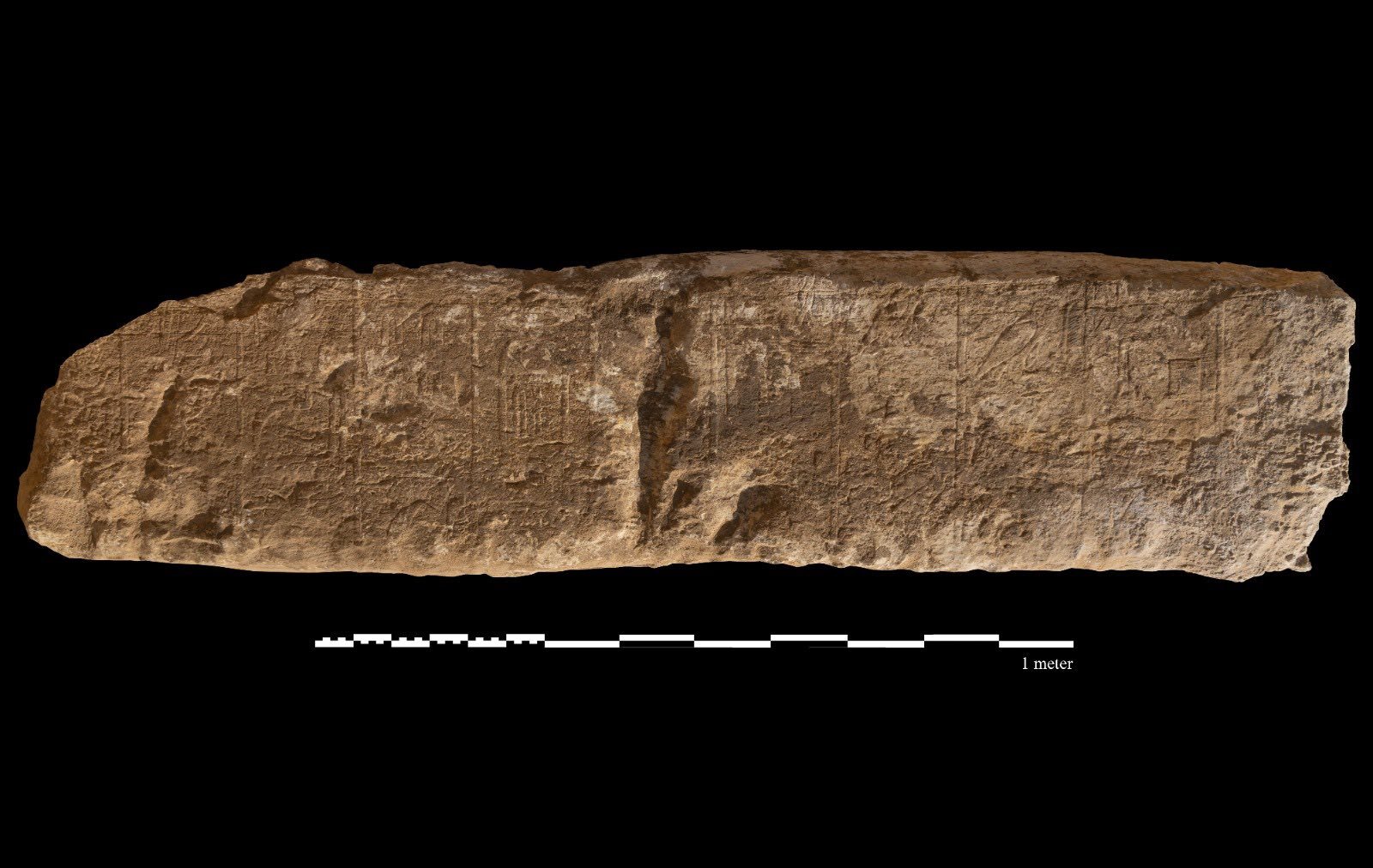 A carved stone against a black background