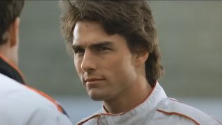 Tom Cruise in 1990 looking determined and wearing NASCAR gear in Days of Thunder.