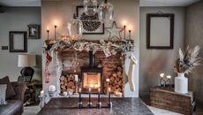 rustic sitting room with stone fireplace dressed for Christmas