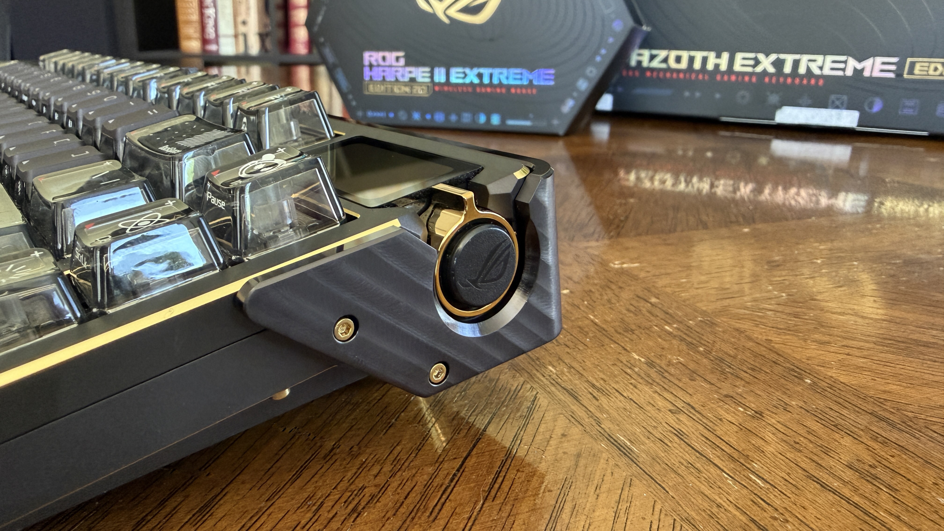 Close-up of an ASUS Azoth Extreme Edition 20 mechanical gaming keyboard with a focus on the volume knob and keycaps.