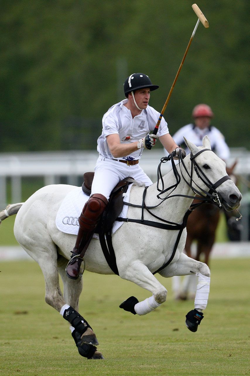 Prince William riding a horse in a polo match