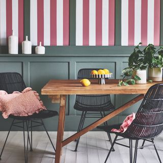 dining room with green panelling and red and white stripe walls