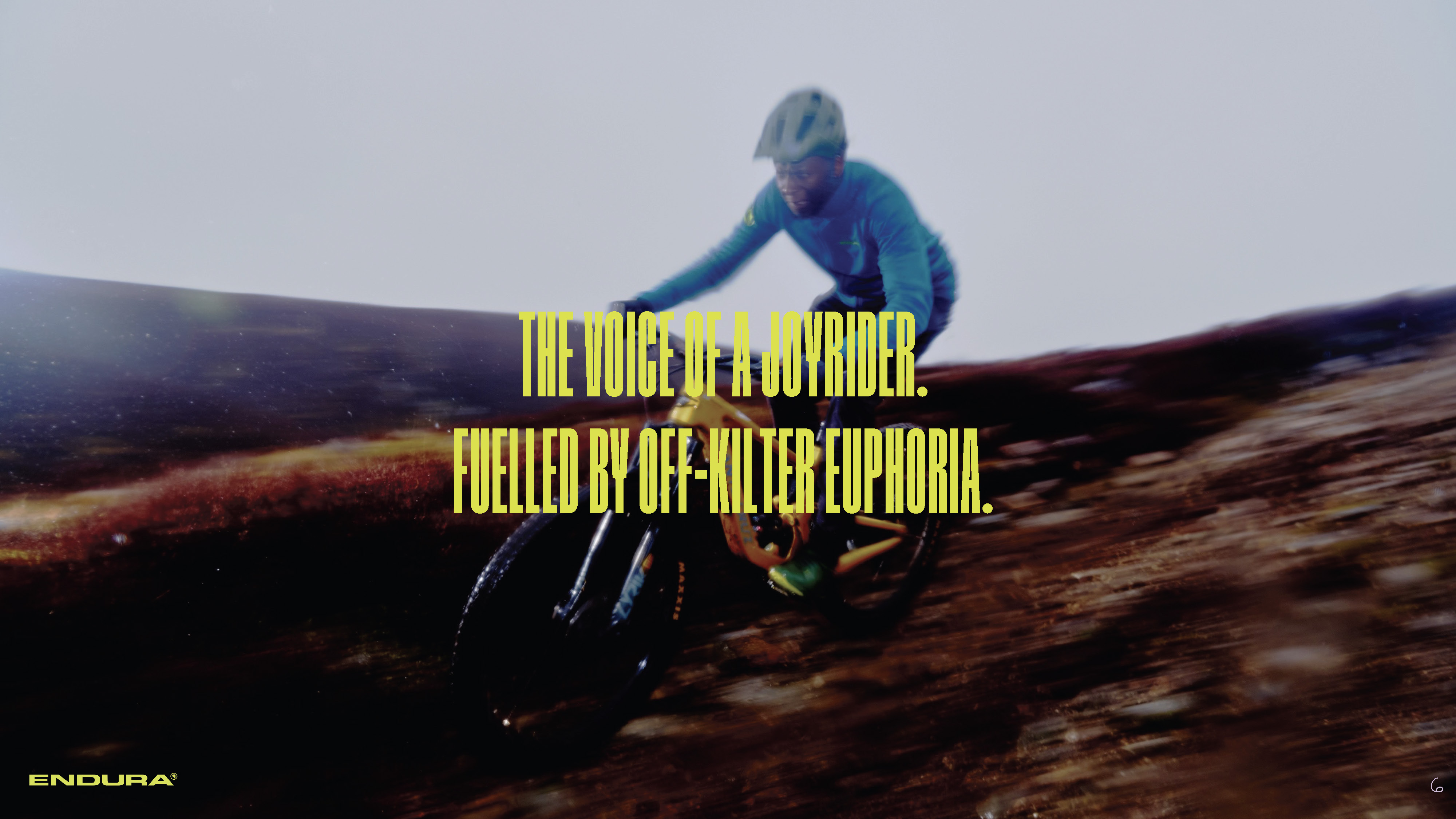 cyclist up a hill with text that says 'the voice of a joyrider. Fuelled by off-kilter euphoria
