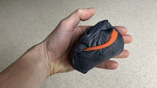 Windproof jacket in small bundle in a hand