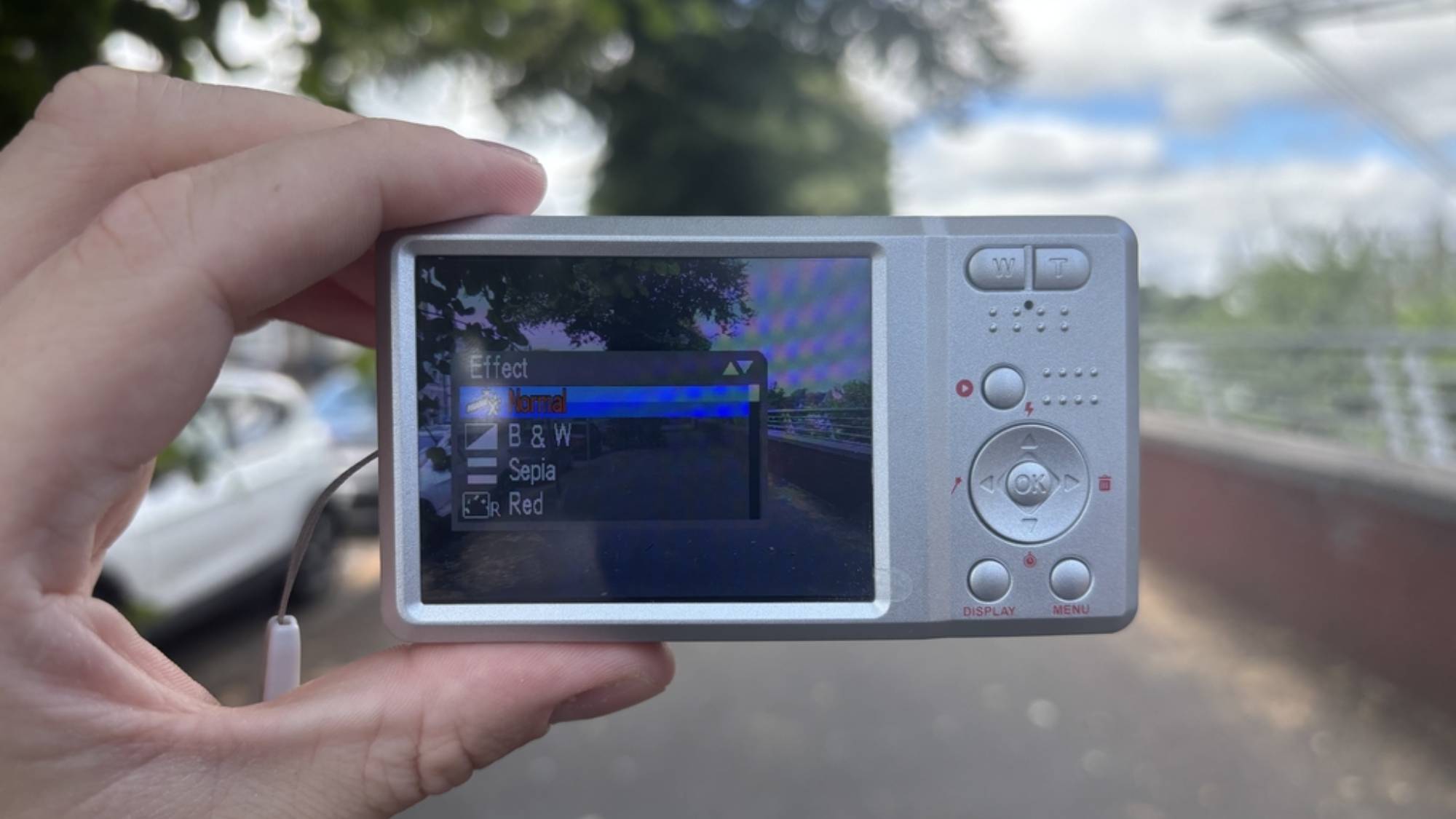 Someone holding the Lola digital camera with the effects menu displayed