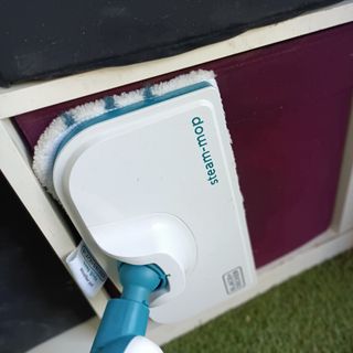 Closeup of the Black & Decker 10-in-1 Steam Mop cleaning a seat cushion