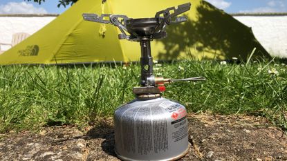 Soto WindMaster 4-Flex Stove review: the stove on the ground in front of a tent
