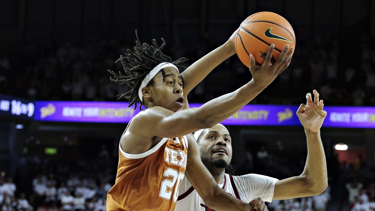 Tre Johnson #20 of the Texas Longhorns drives to the basket in the second half against Jonas Aidoo #9 of the Arkansas Razorbacks at Bud Walton Arena ahead of March Madness 2025 LIVE (Photo by Wesley Hitt/Getty Images)