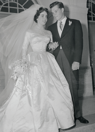 Elizabeth Taylor and Conrad Nicholson Hilton Jr. stand on the steps of the Church of the Good Shepherd in Beverly Hills after their wedding in 1950