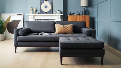 A chaise sofa with grey upholstery in a mid-Century inspired living room