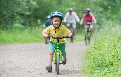 A little boy riding a Frog bike in the UK