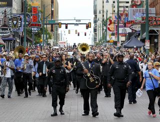 Ahead of the hearse carrying BB King's coffin, Rodd Bland, son of Bobby 'Blue' Bland, carries BB's Gibson Lucille guitar and leads a procession down Beale Street in Memphis.