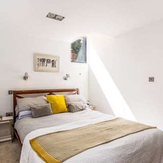 knappings barn bedroom with minimalist white walls and beige carpets