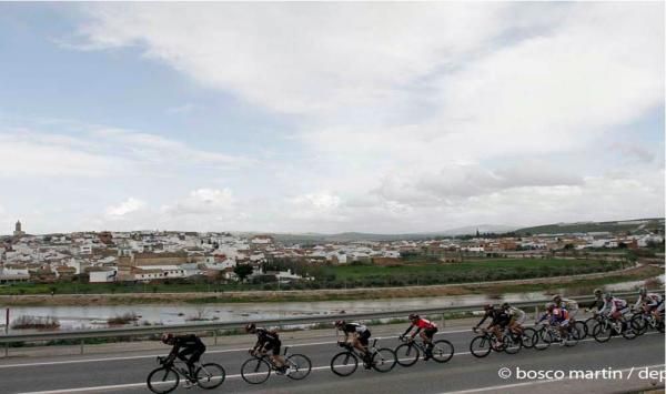 The peloton rides past a town in southern Spain
