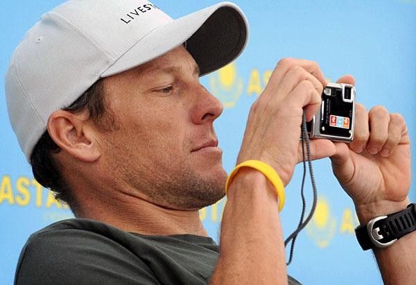 Armstrong shoots back to get his memory pictures from the media representatives.