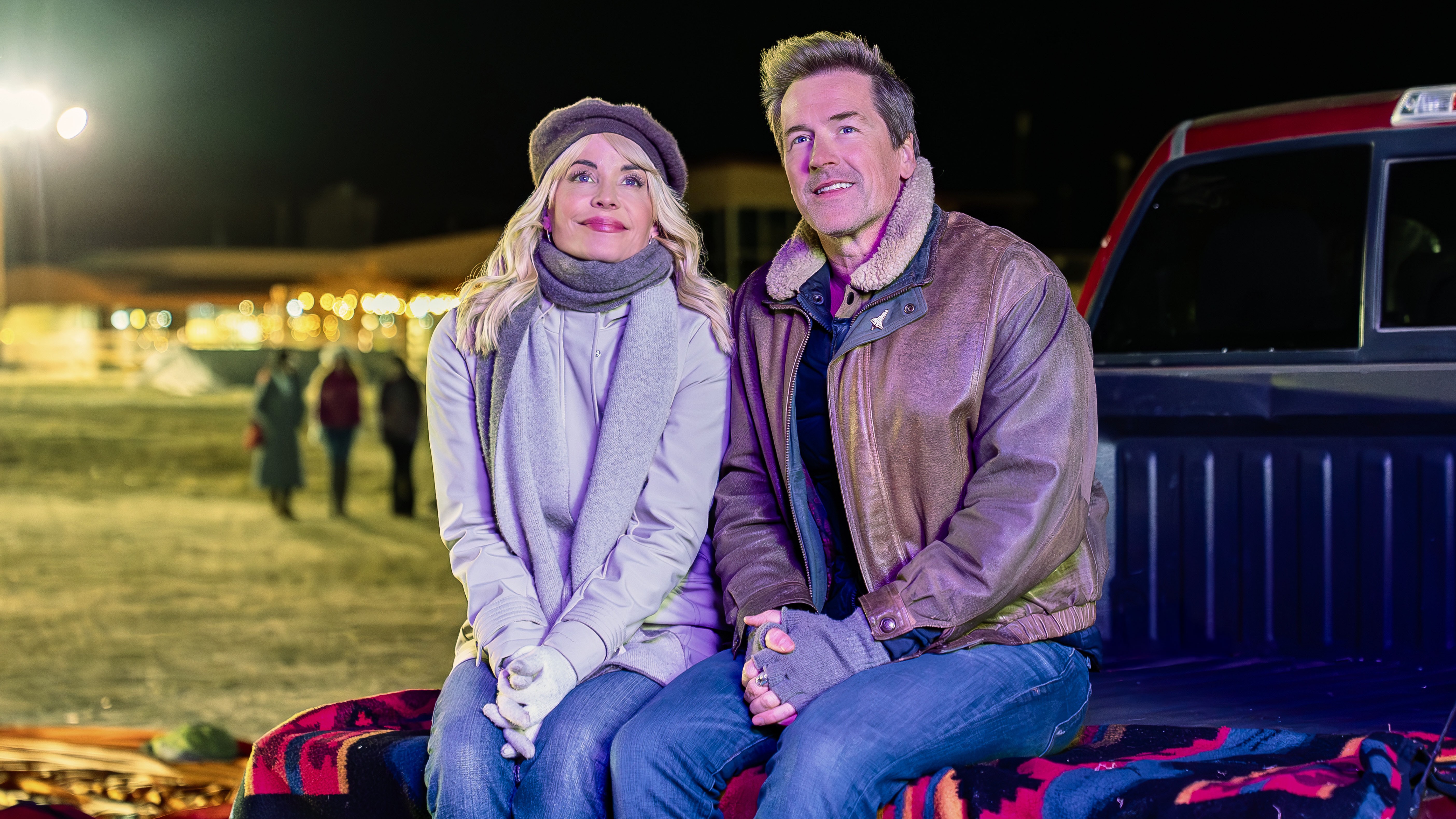 McKenzie Westmore, Paul Greene sitting in the back of a truck looking up in the sky in Love in the Clouds