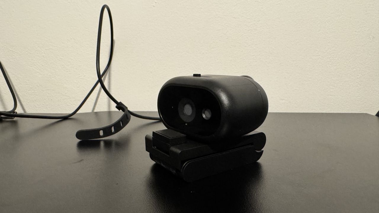 Dell Pro 5 webcam on its stand on top of a black table
