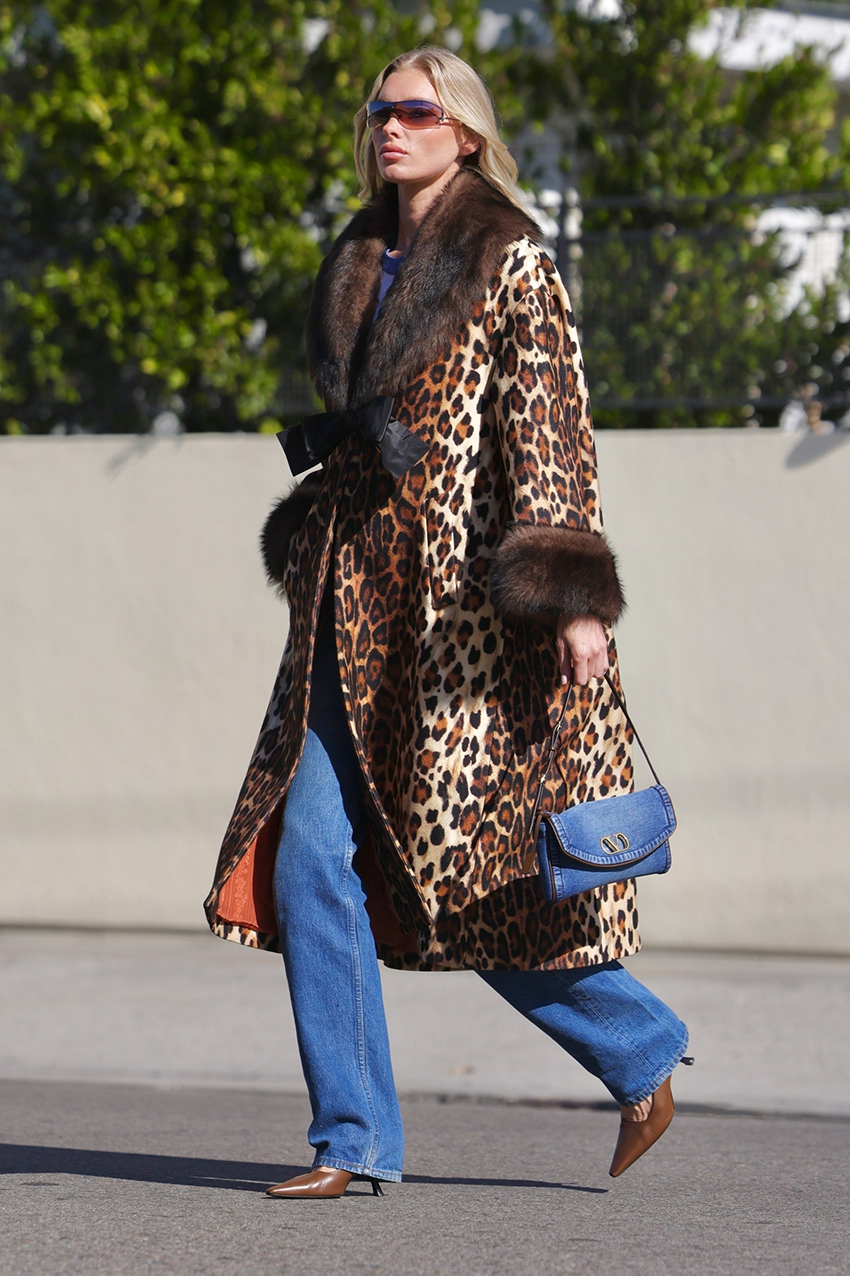 Elsa Hosk wearing a leopard coat, denim Valentino bag, jeans, and cognac pumps