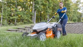 Sara Bendrick cutting lawn with Stihl mower