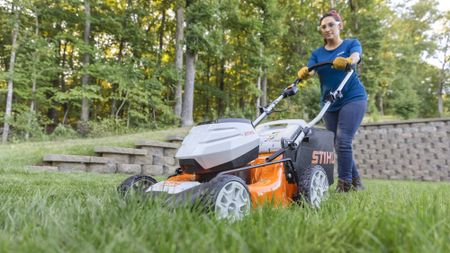 Sara Bendrick cutting lawn with Stihl mower