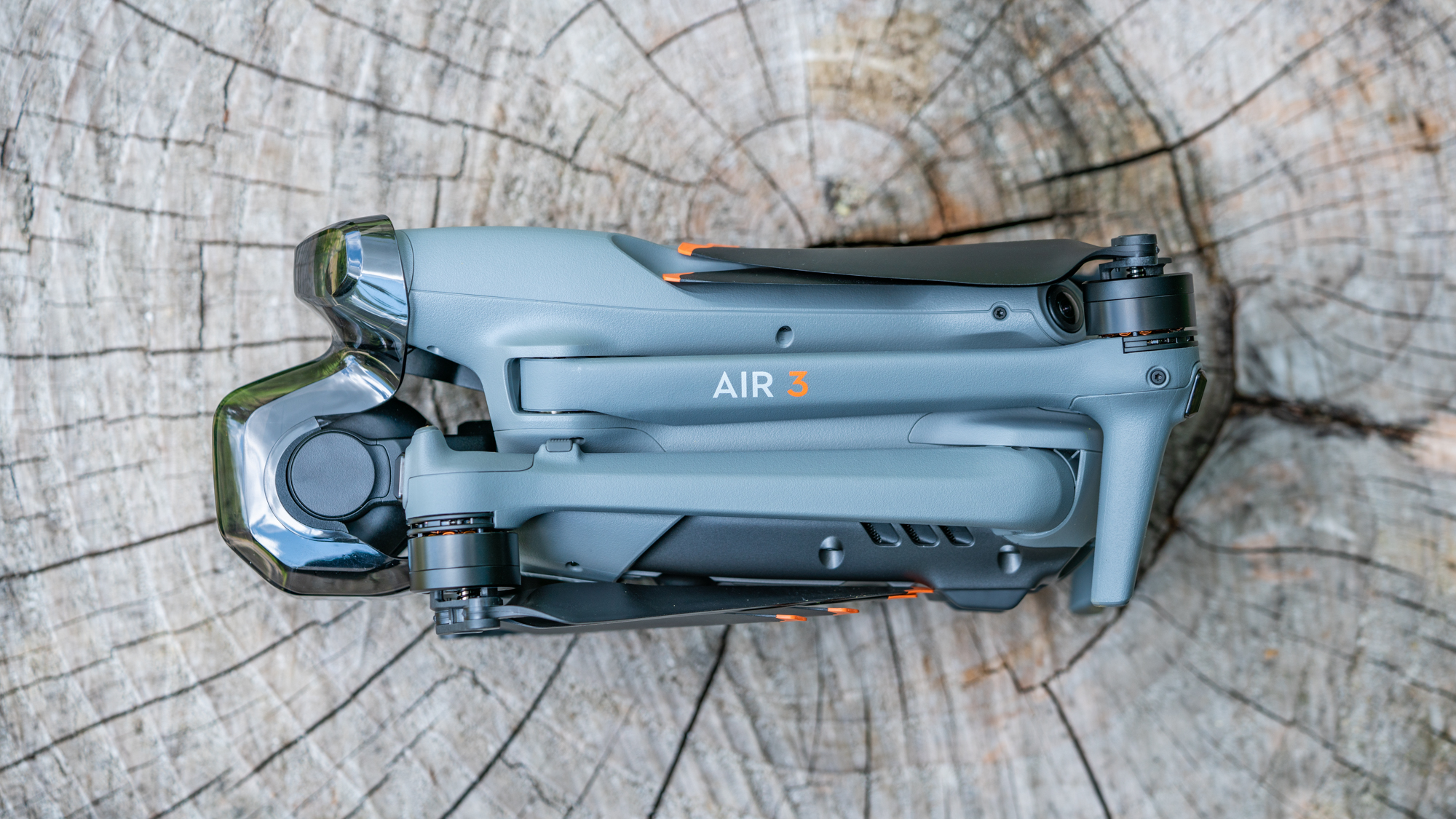 DJI Air 3 drone on a tree stump with arms and propellors folded away