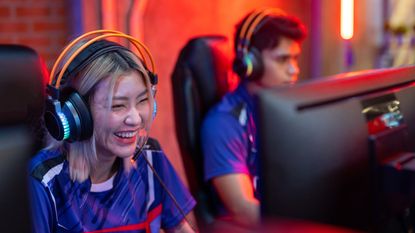 A guy and girl playing games in an esports team