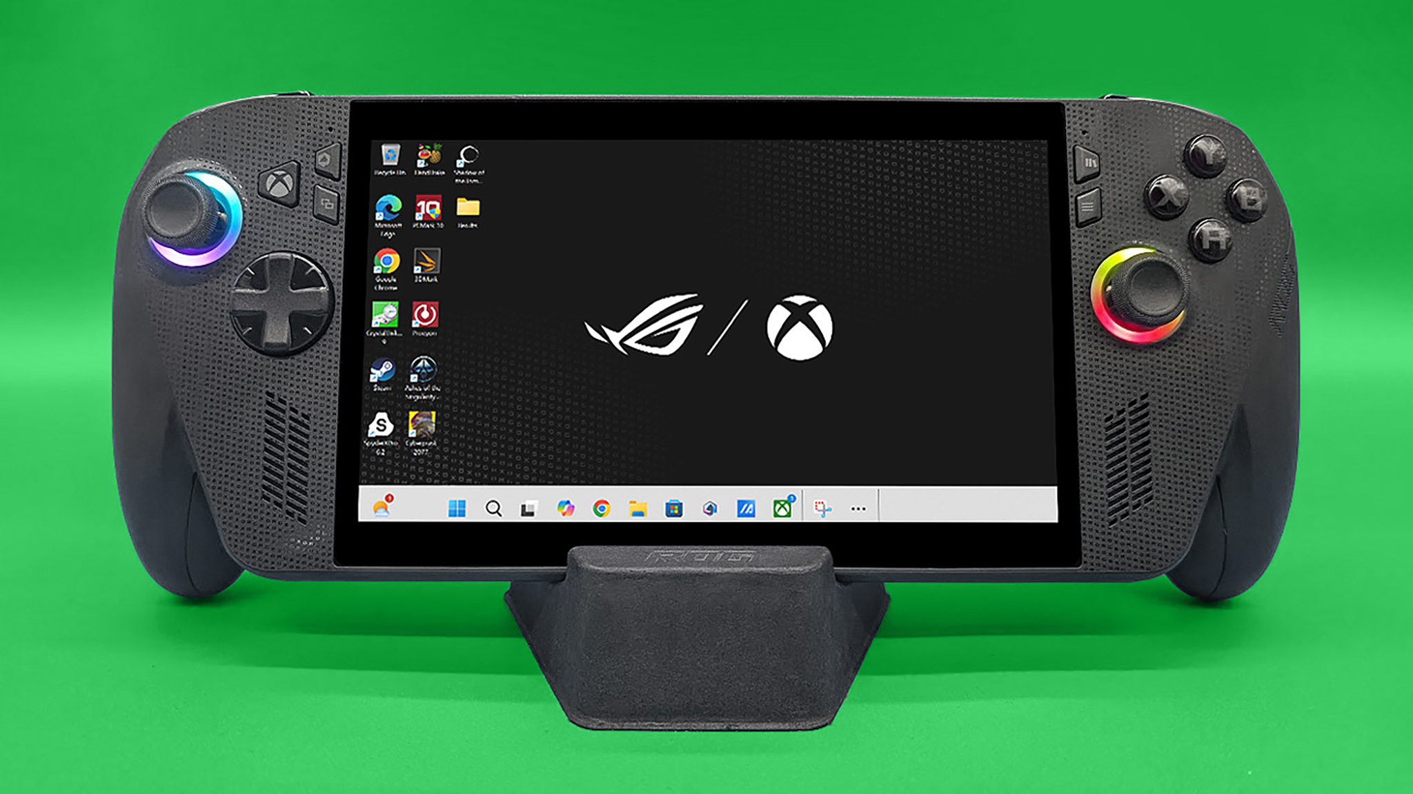 ROG Xbox Ally X held upright in its stand and showing the main background that features the ASUS ROG logo and the Xbox logo.