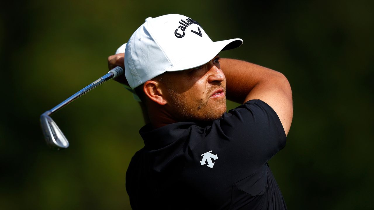 Xander Schauffele plays an iron shot