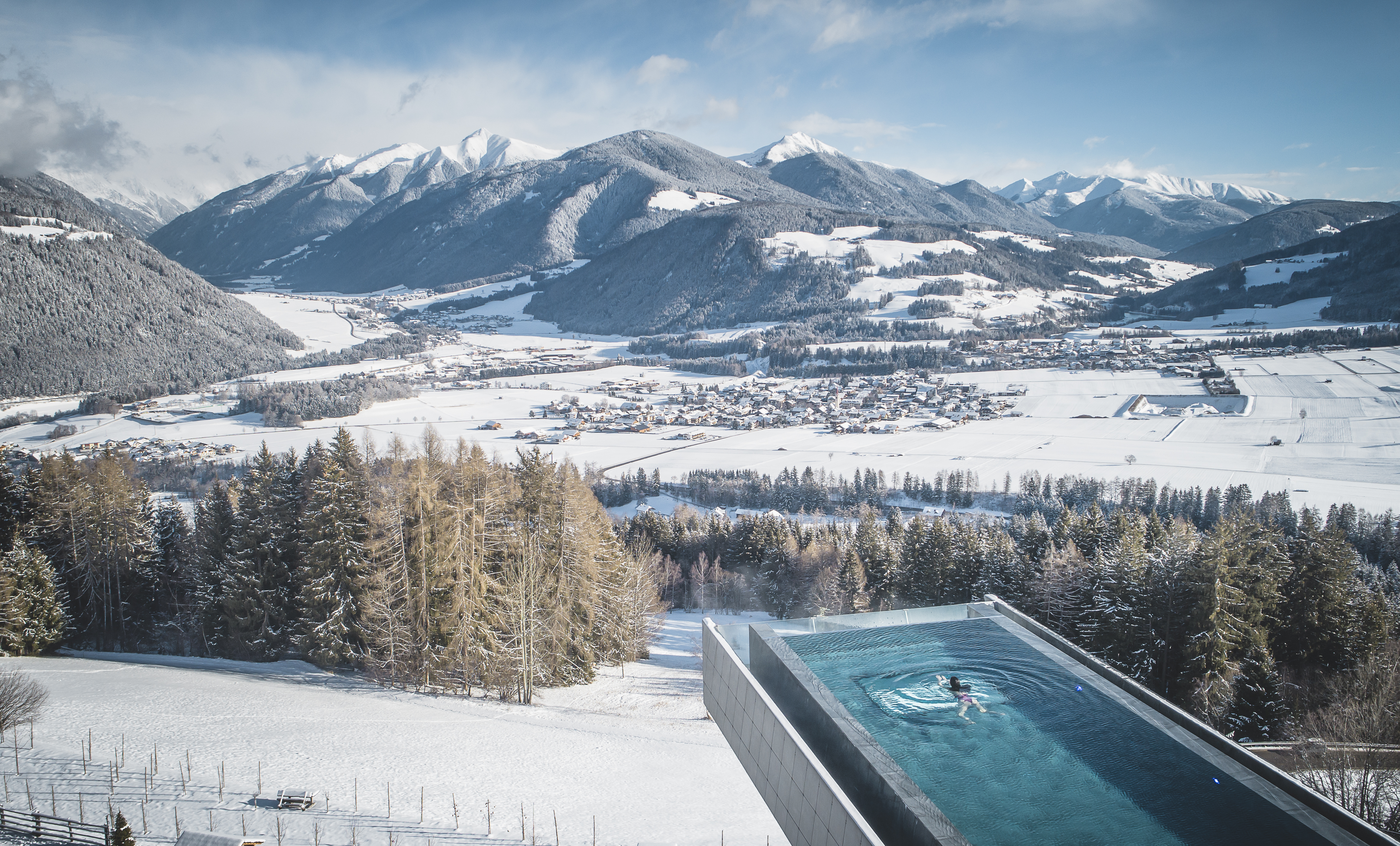 A design-forward mountain escape's sleek, minimalist design in wood, cement, and stone contrasts with the wilderness of its outdoors.