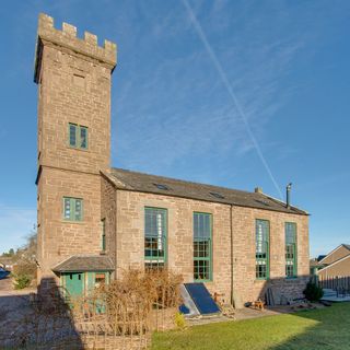 steeple house with stone walls and panelled windows