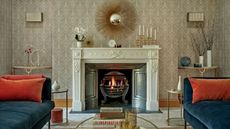 Cozy fireplace in carpeted living room with blue velvet sodas