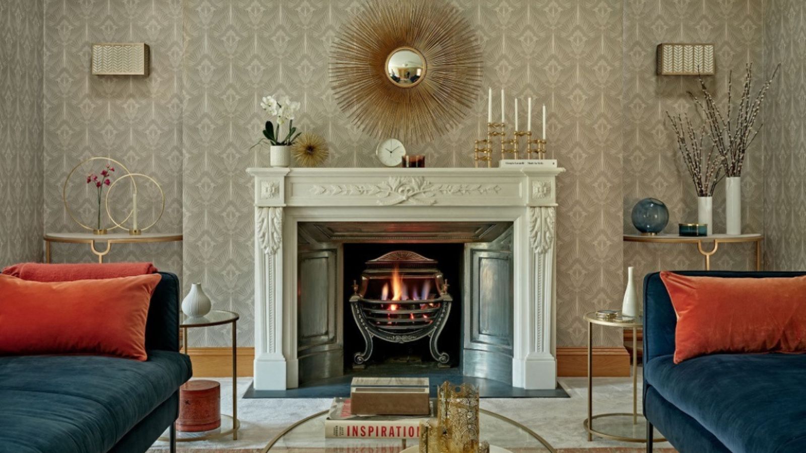 Cozy fireplace in carpeted living room with blue velvet sodas