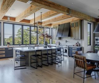 Industrial style kitchen with wooden beams and wooden cabinets with steel countertops