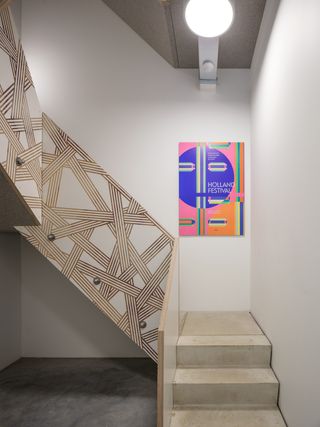 Wood staircase with abstract designs in the Thonik office building