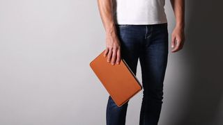 Man carrying Harber London Slim Leather MacBook Sleeve, one of the best MacBook Pro cases