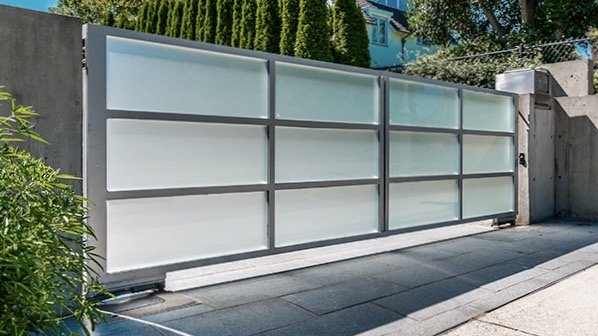 Driveway gate in a closed position preventing access to a home