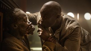 Djimon Hounsou putting his hand over Lupita Nyong'o's mouth in A Quiet Place: Day One