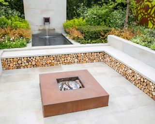 patio with fire pit and surrounding seating and water feature