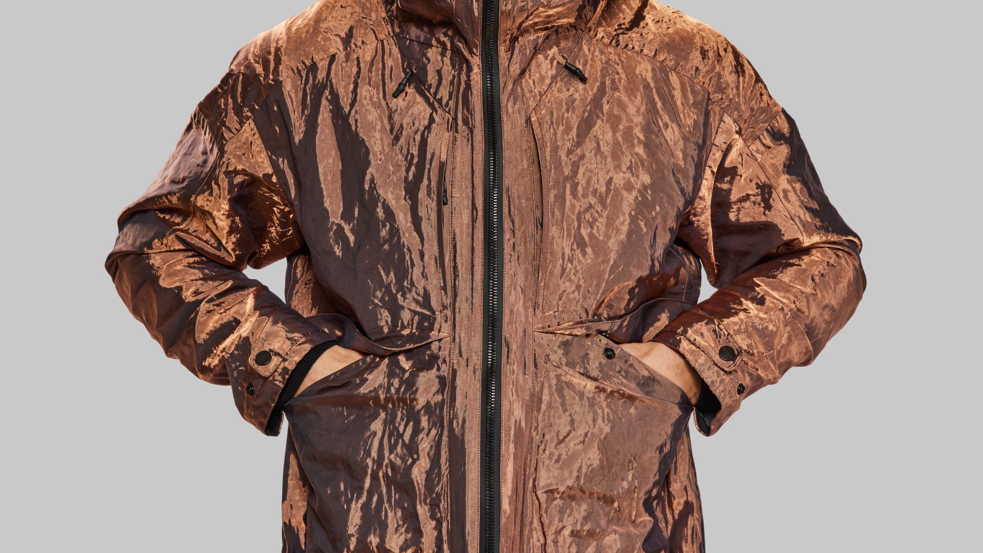 an image of a copper coloured coat with two mid pockets