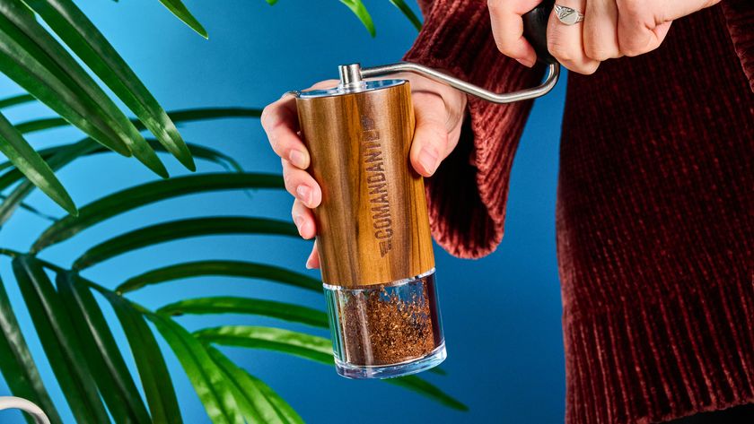 the comandante c40 mk4 hand coffee grinder with a glass catch chamber and high nitrogen steel burrs