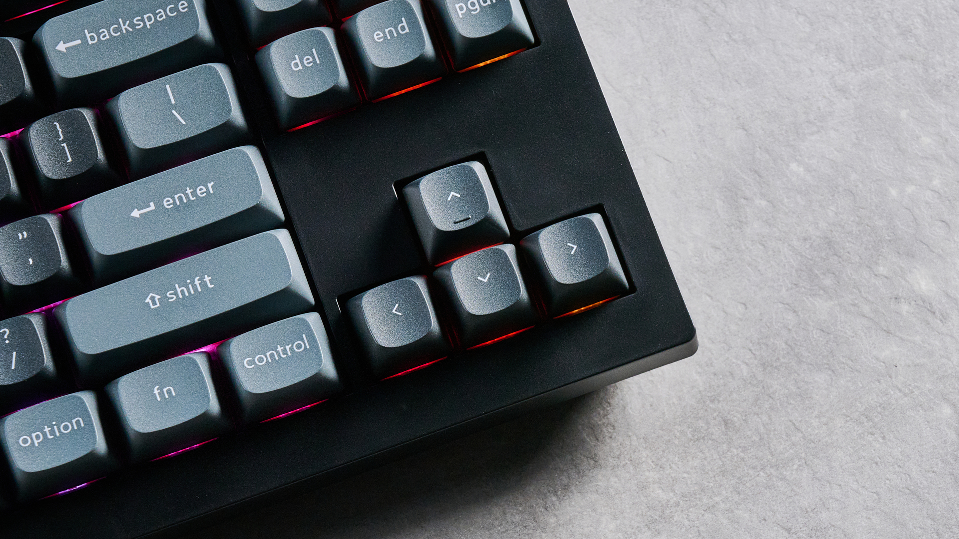 Keychron V3 Ultra 8K photographed on a grey table top in front of a blue background