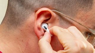 Putting an AirPods Pro earbud in my ear