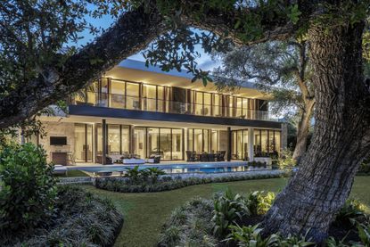 Hero exterior with nighttime lighting at the Tarpon Bend Residence by Strang Design
