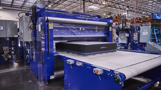 A mattress being rolled and packed at the 3z factory