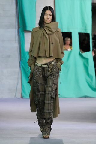 Woman in plaid pants and trench jacket